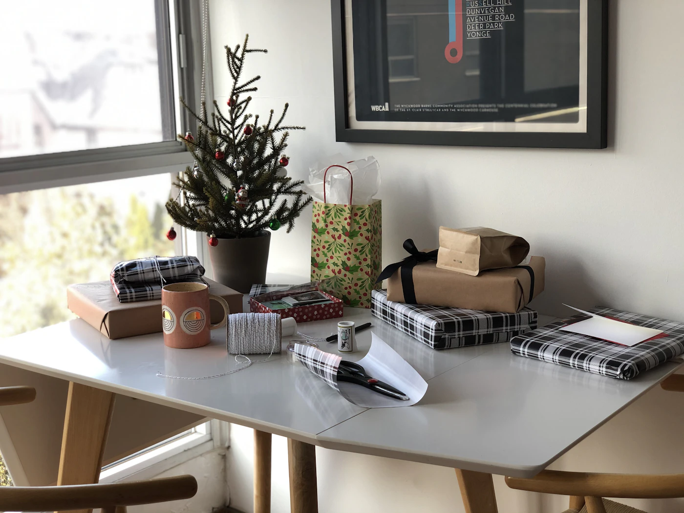 The front desk of Jingles McSprocket's workshop, warm and inviting with a sign reading 'Welcome, All Visitors (Except Grinches)'